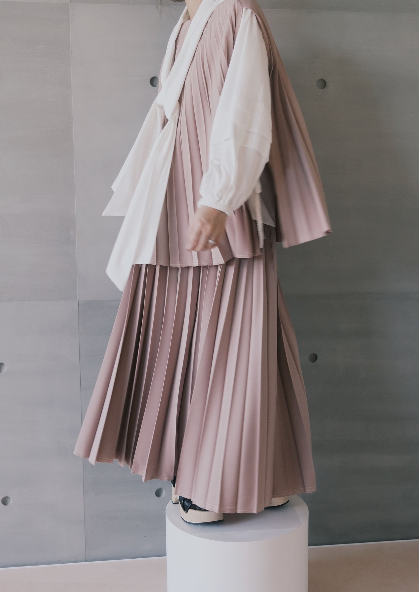 raw-edge curved-hem pleated top