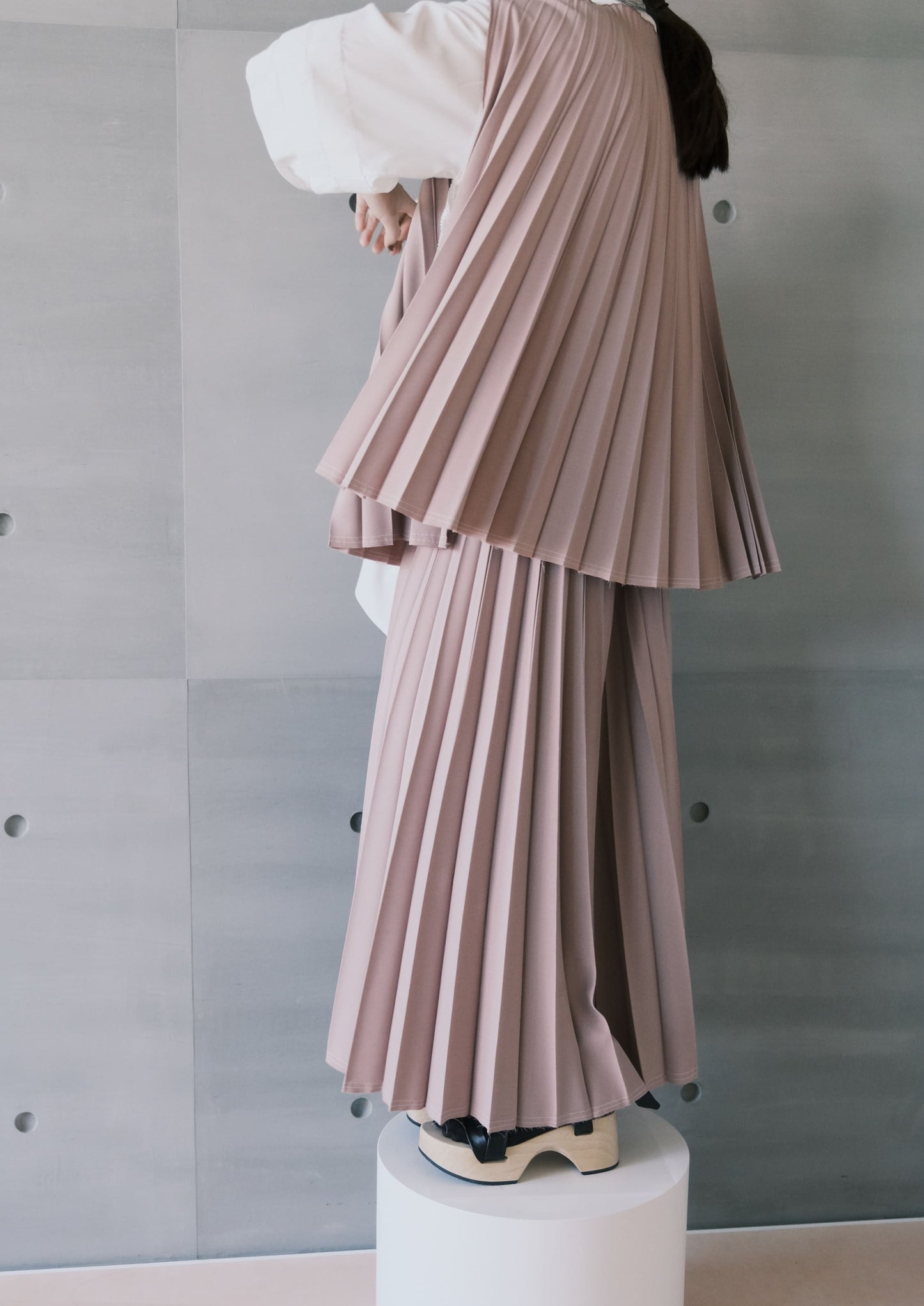 raw-edge curved-hem pleated top